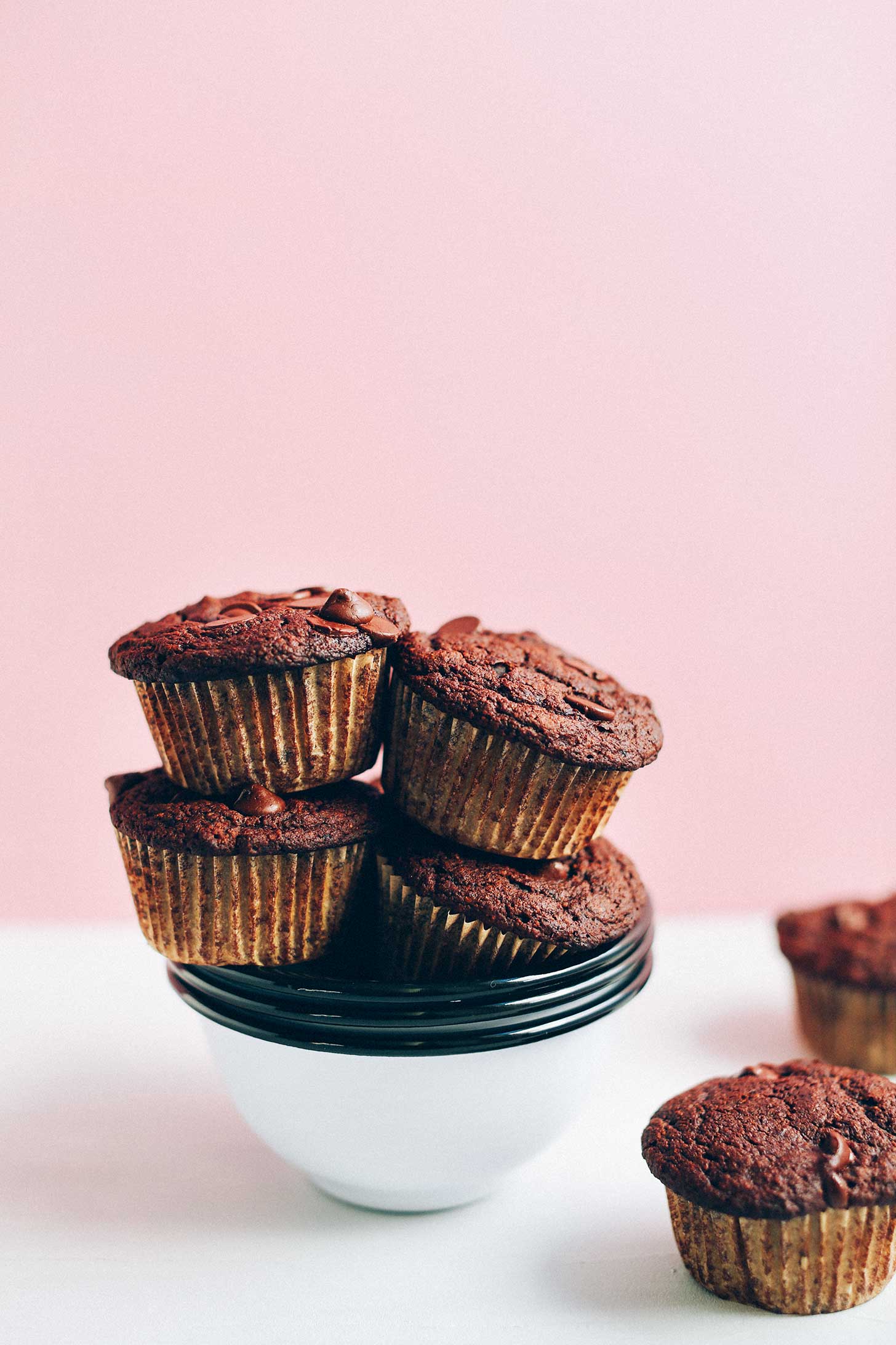 Bowl of stacked gluten-free Vegan Double Chocolate Muffins