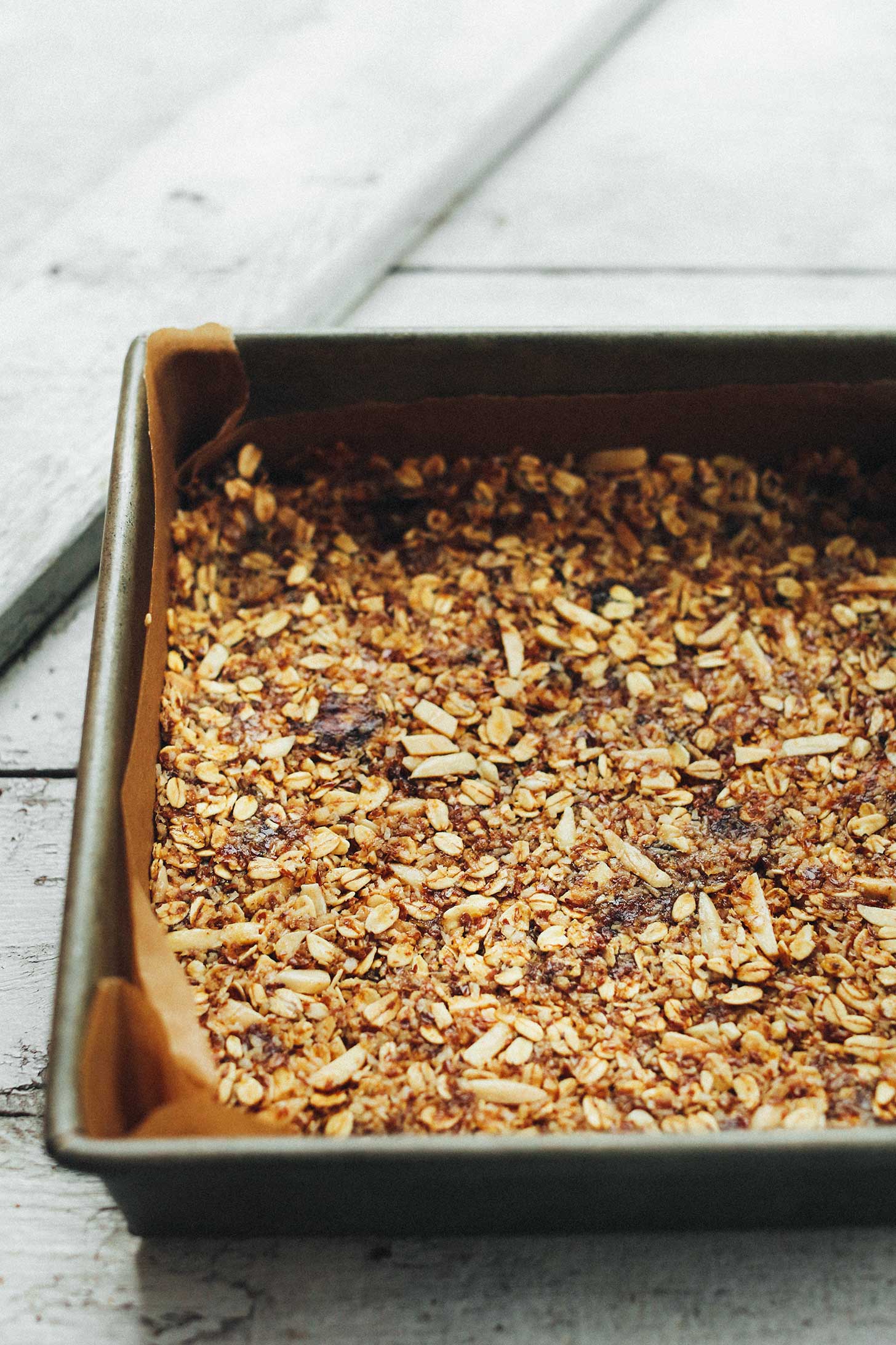 Parchment-lined baking pan filled with the Best Crunchy Baked Granola Bars