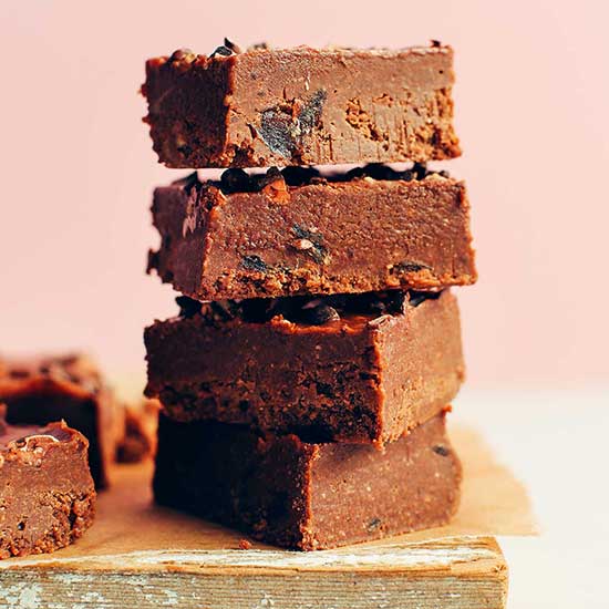 Stack of four slices of Vegan Chocolate Fudge made with dates