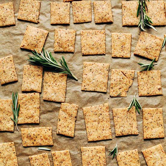 Parchment-lined baking sheet of Vegan GF Rosemary Crackers