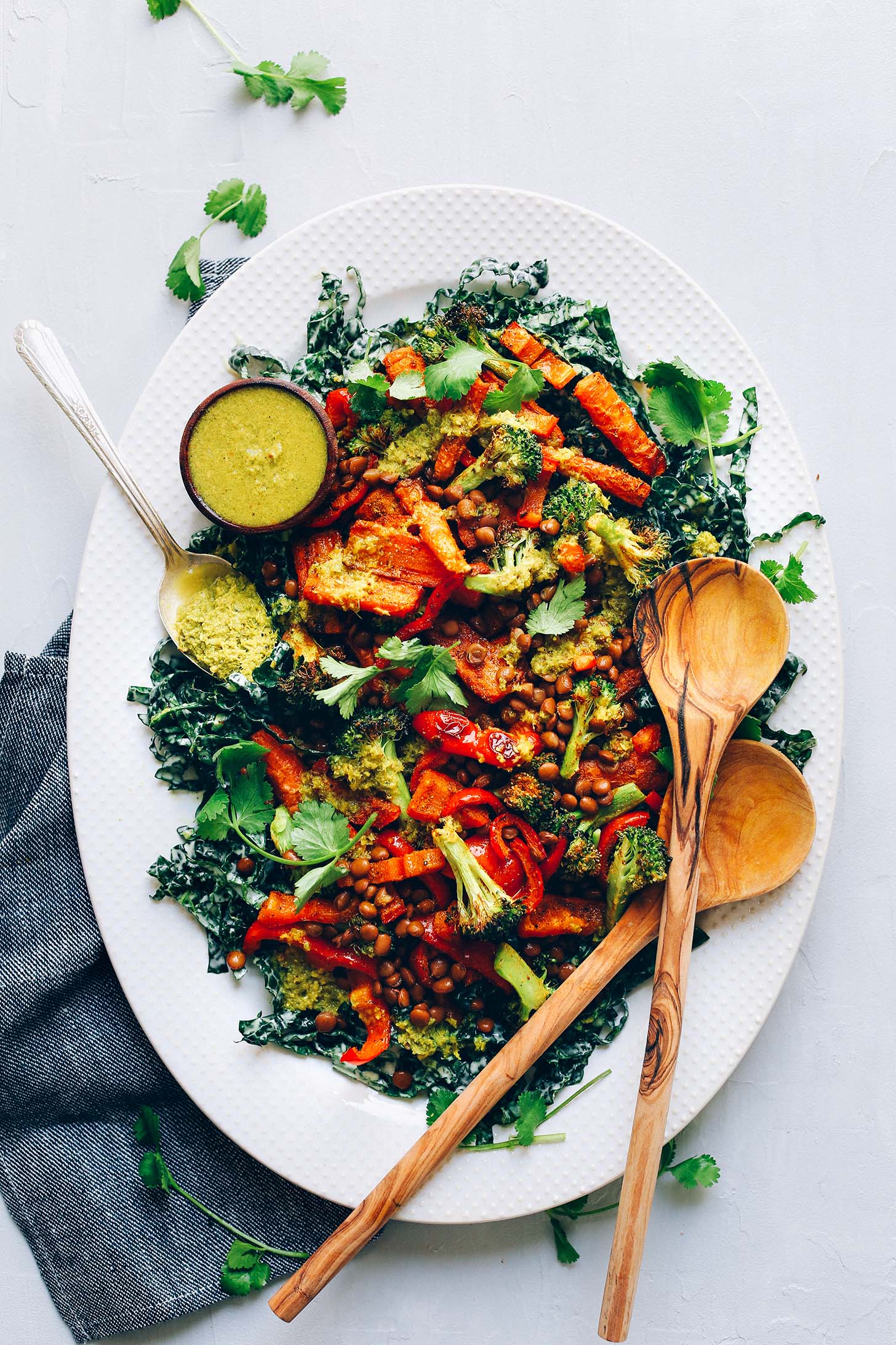 Platter of colorful plant-based Curried Lentil Salad with Kale, Roasted Veggies, and Green Curry Dressing