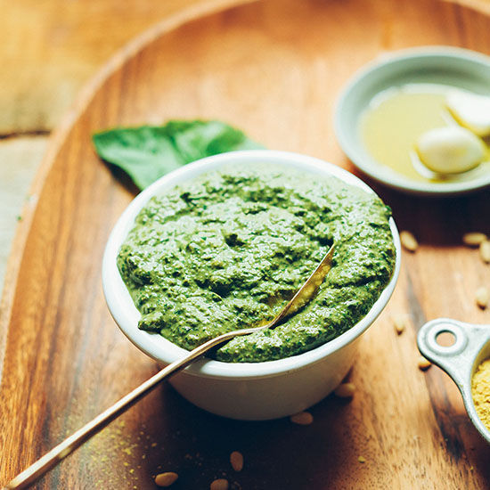 Spoon resting in a bowl of our Easy Vegan Pesto recipe