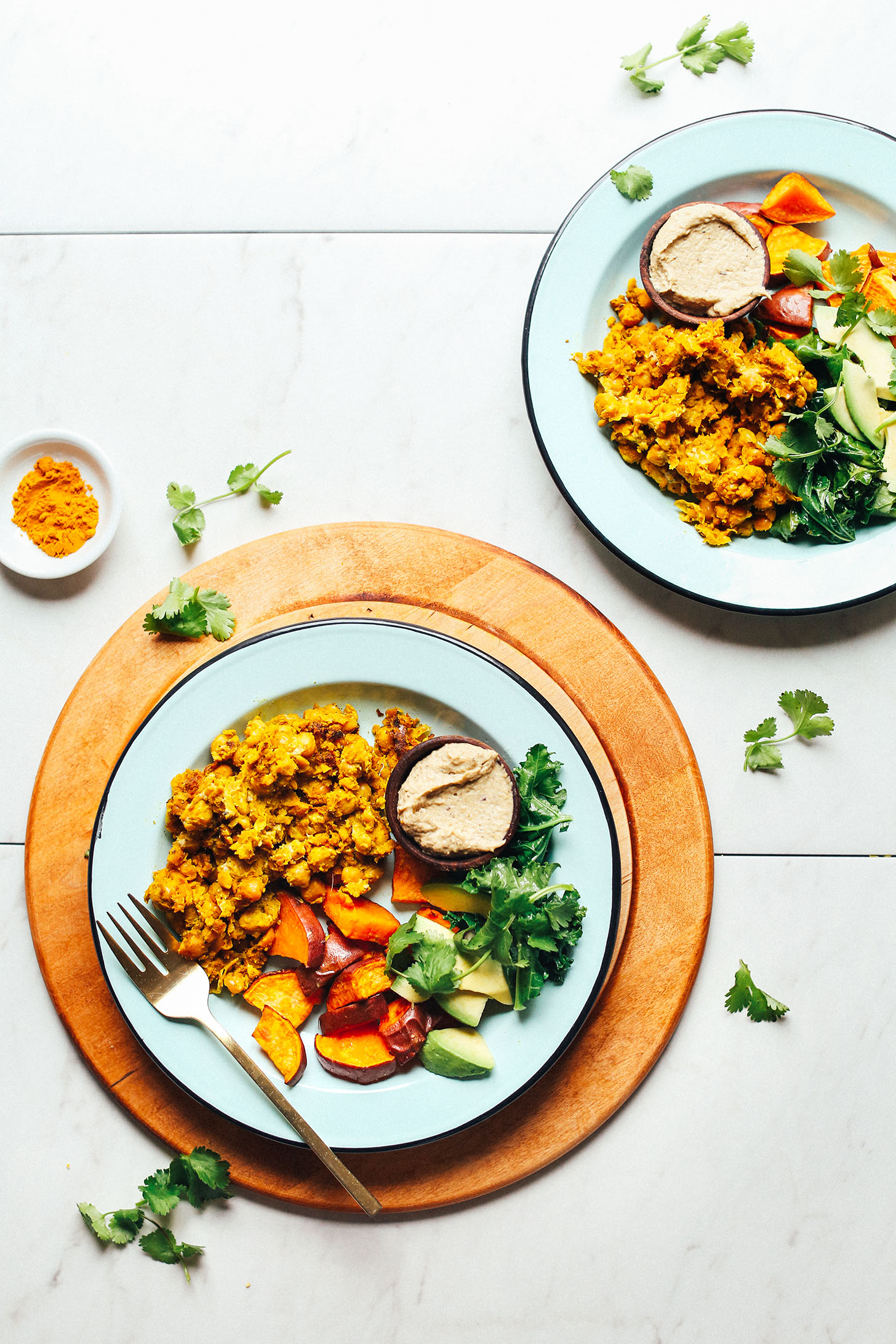 Plate with delicious Chickpea Scramble, roasted sweet potatoes, avocado, cilantro, and baba ghanoush
