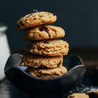 Bowl stacked with a leaning tower of Almond Butter Chocolate Chip Cookies