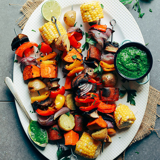 Platter of Grilled Veggie Skewers with a small dish of Chimichurri sauce