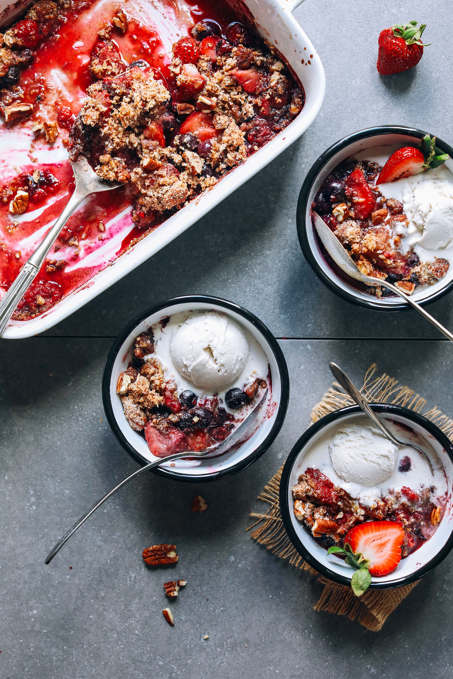 Dessert bowls filled with gluten-free berry crisp and vegan ice cream