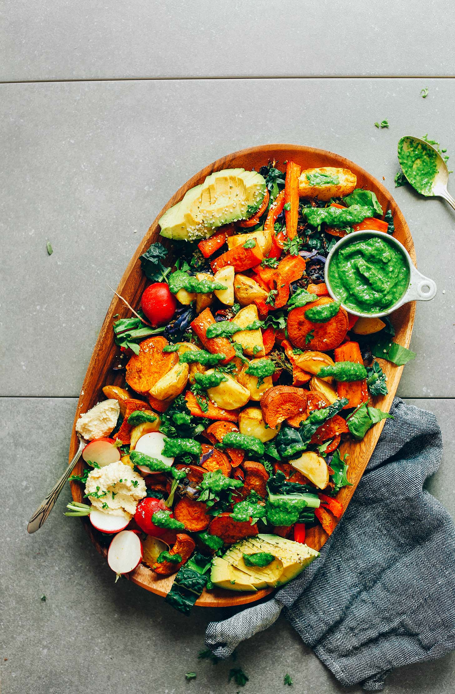 Wood platter with Roasted Vegetable Salad & Chimichurri for a gluten-free healthy meal