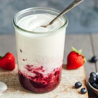 Jar of homemade Easy Coconut Yogurt with fruit compote at the bottom