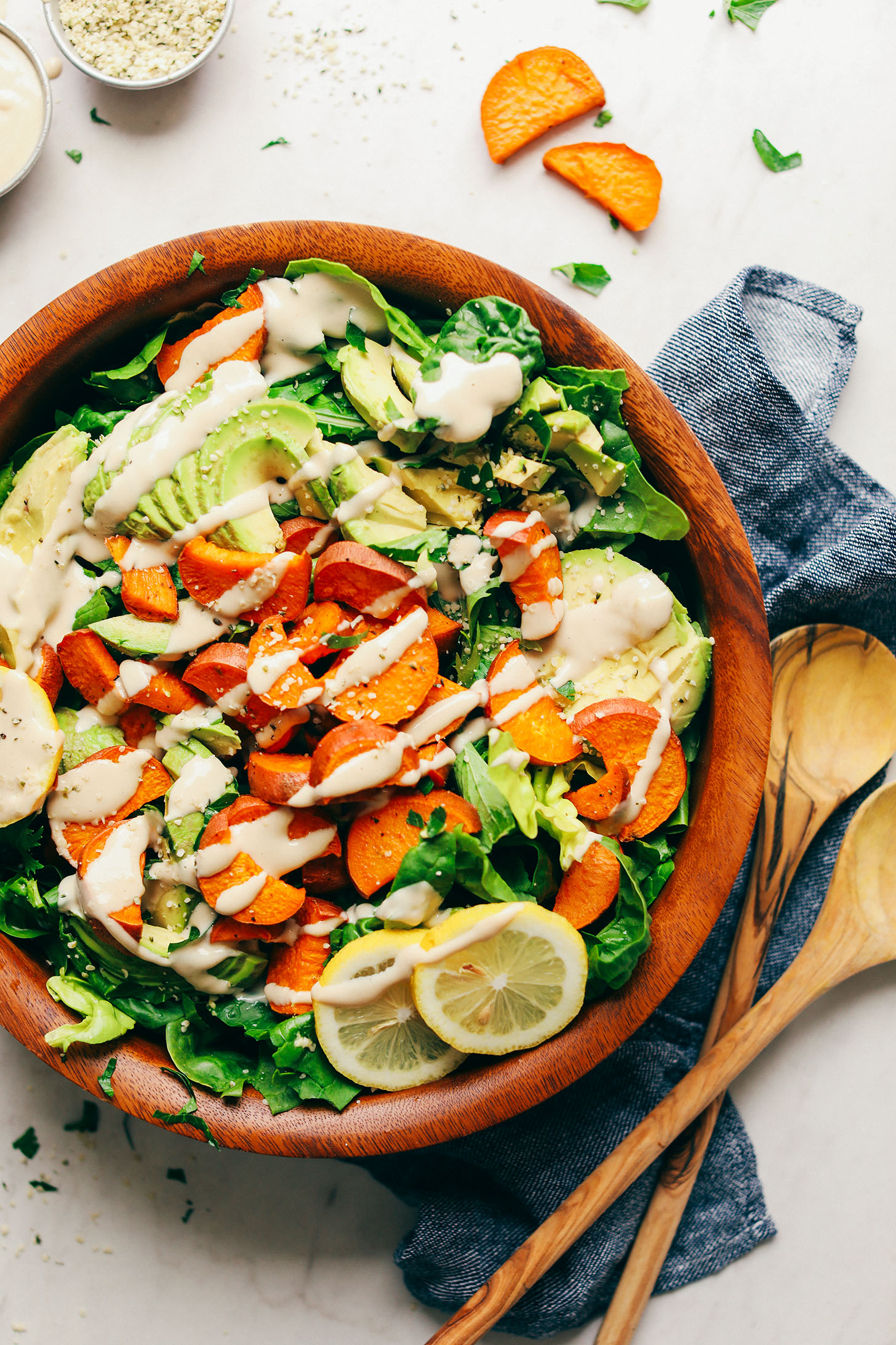 Healthy plant-based Green Salad with Sweet Potatoes, Avocado, and Tahini Dressing