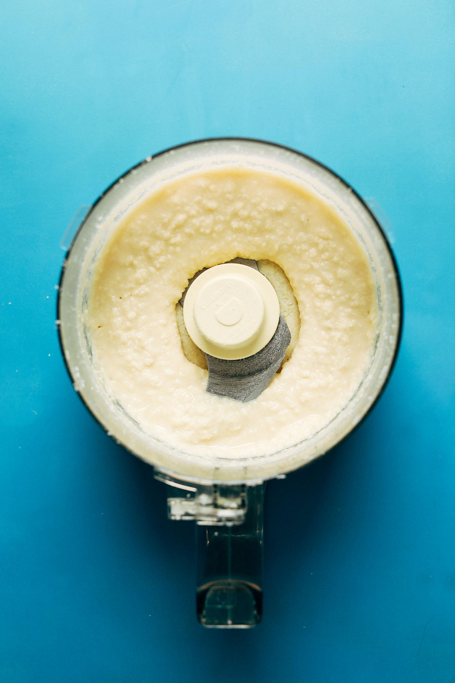 Food processor filled with delicious homemade coconut butter