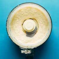 Food processor filled with our delicious homemade coconut butter recipe