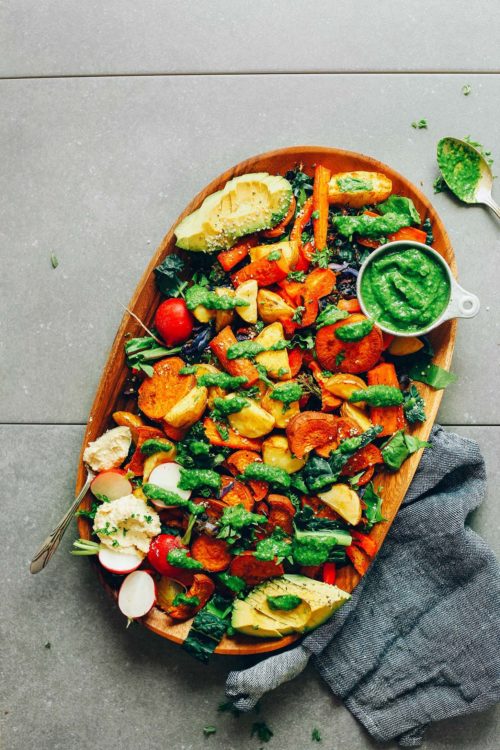 Serving platter filled with Amazing Roasted Vegetable Salad & Chimichurri