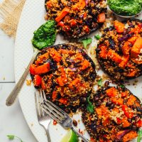 Large serving platter with four Vegetable Quinoa Stuffed Portobello Mushrooms for a healthy plant-based meal
