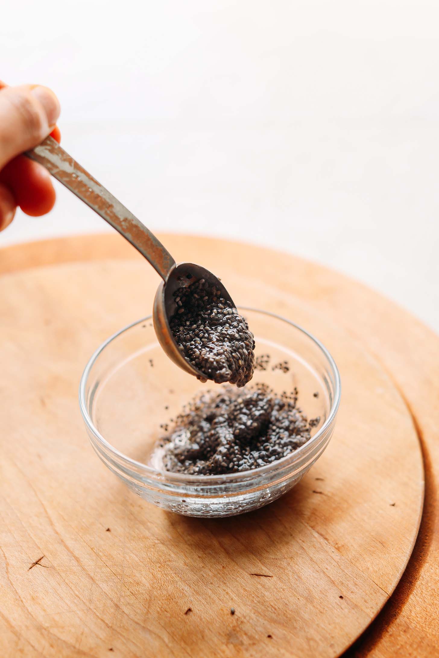 Chia egg dripping off a measuring spoon for our egg-free substitutes guide