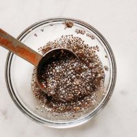 Small bowl of chia seeds and water for an vegan egg substitute