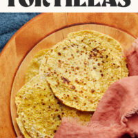 Homemade grain-free plantain tortillas on a wood cutting board
