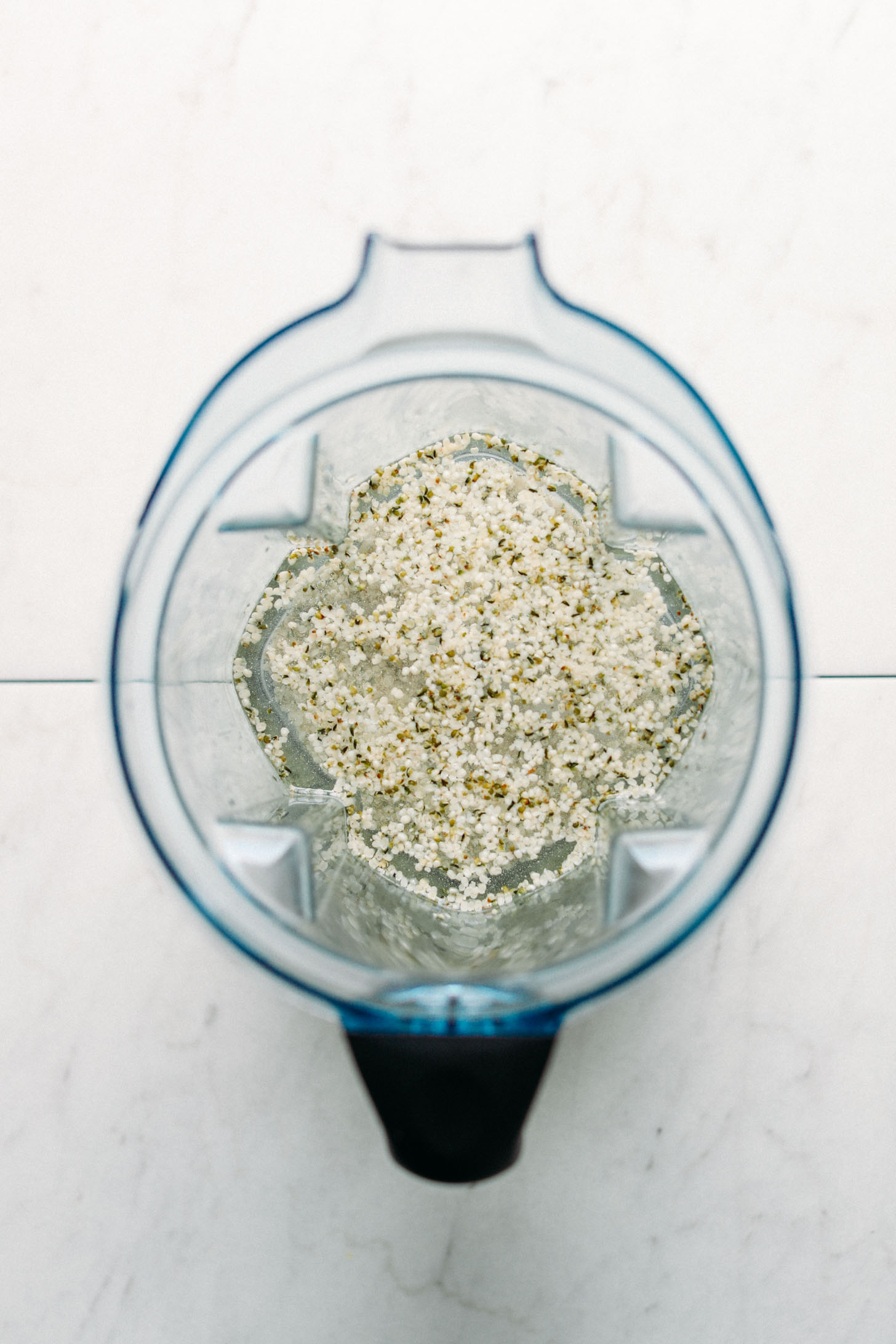 Blender with hemp seeds and other ingredients for making homemade hemp milk