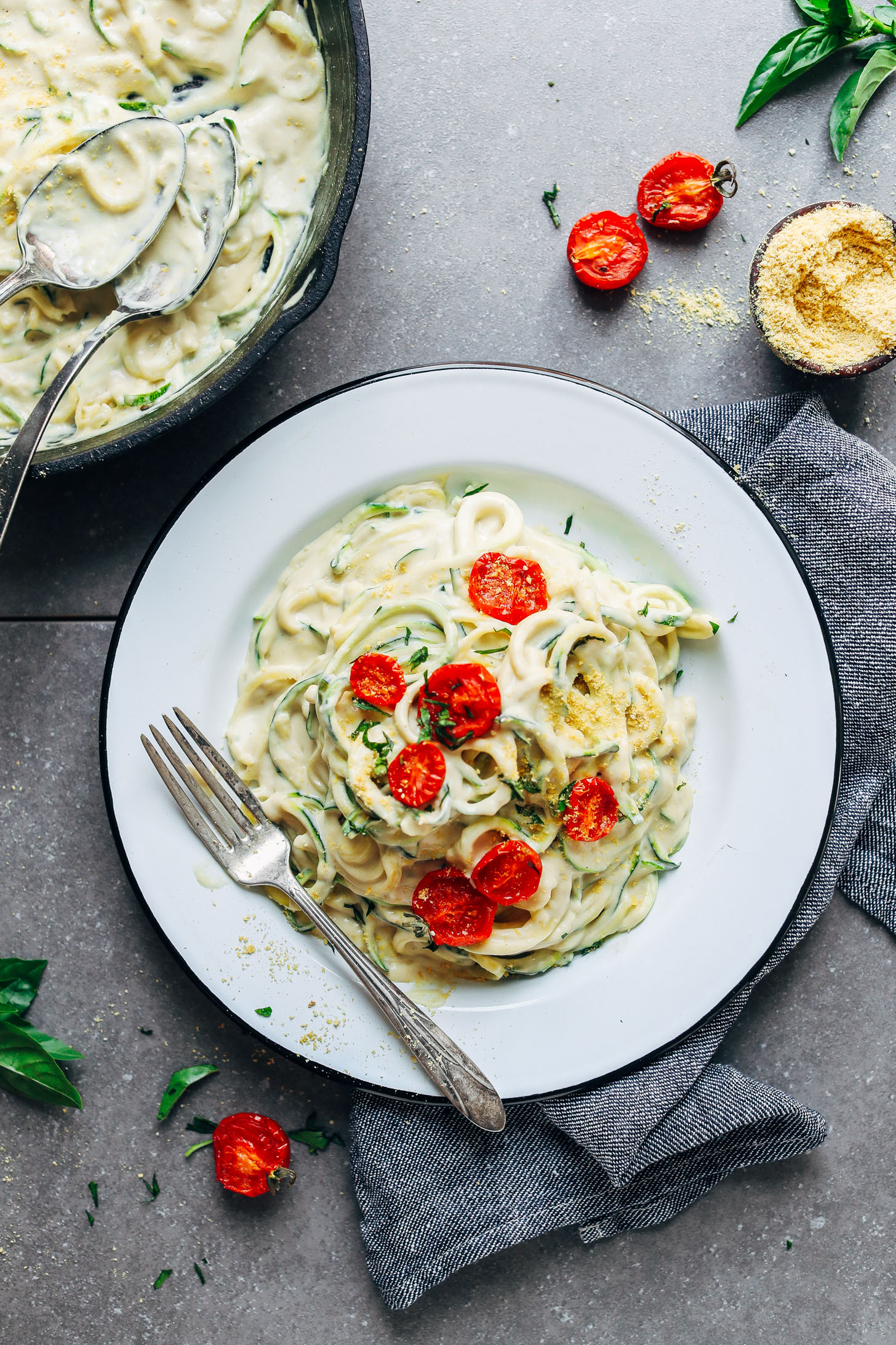 Dinner plate filled with 30-Minute Vegan Alfredo and topped with freshly roasted tomatoes