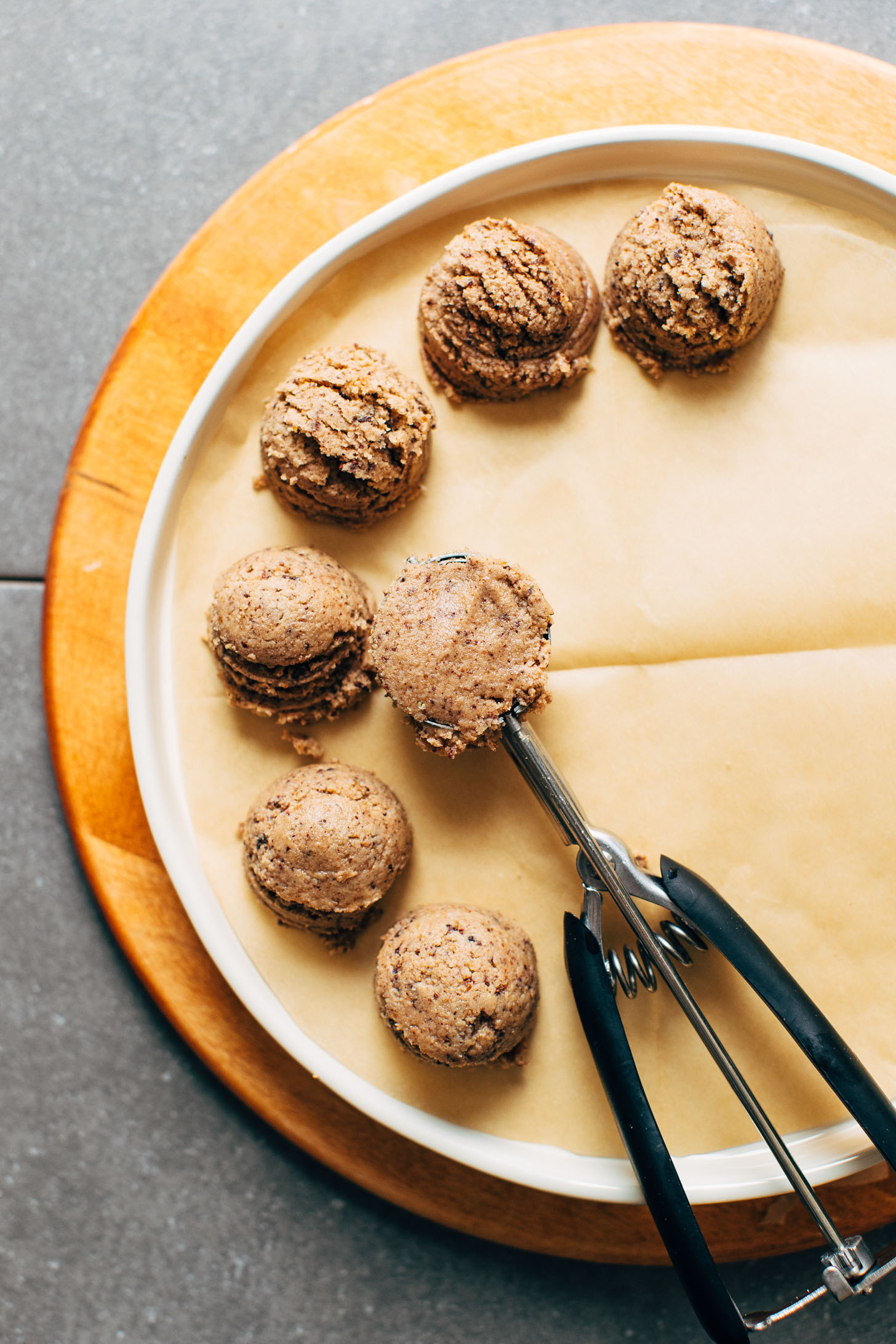 Using a cookie scoop to create the perfect shape for vegan Coconut Cacao Tahini Snack Bites