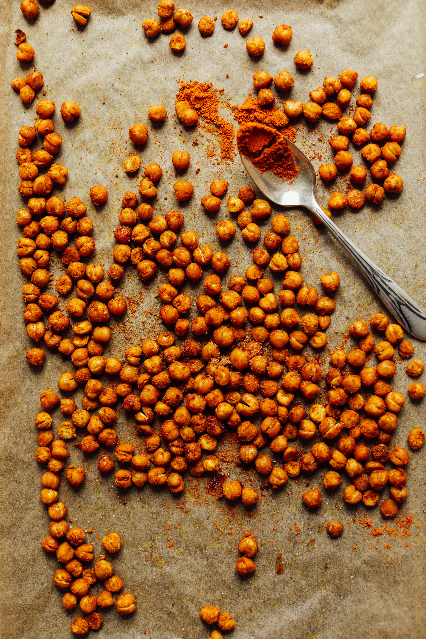 Parchment-lined baking sheet with curried roasted chickpeas