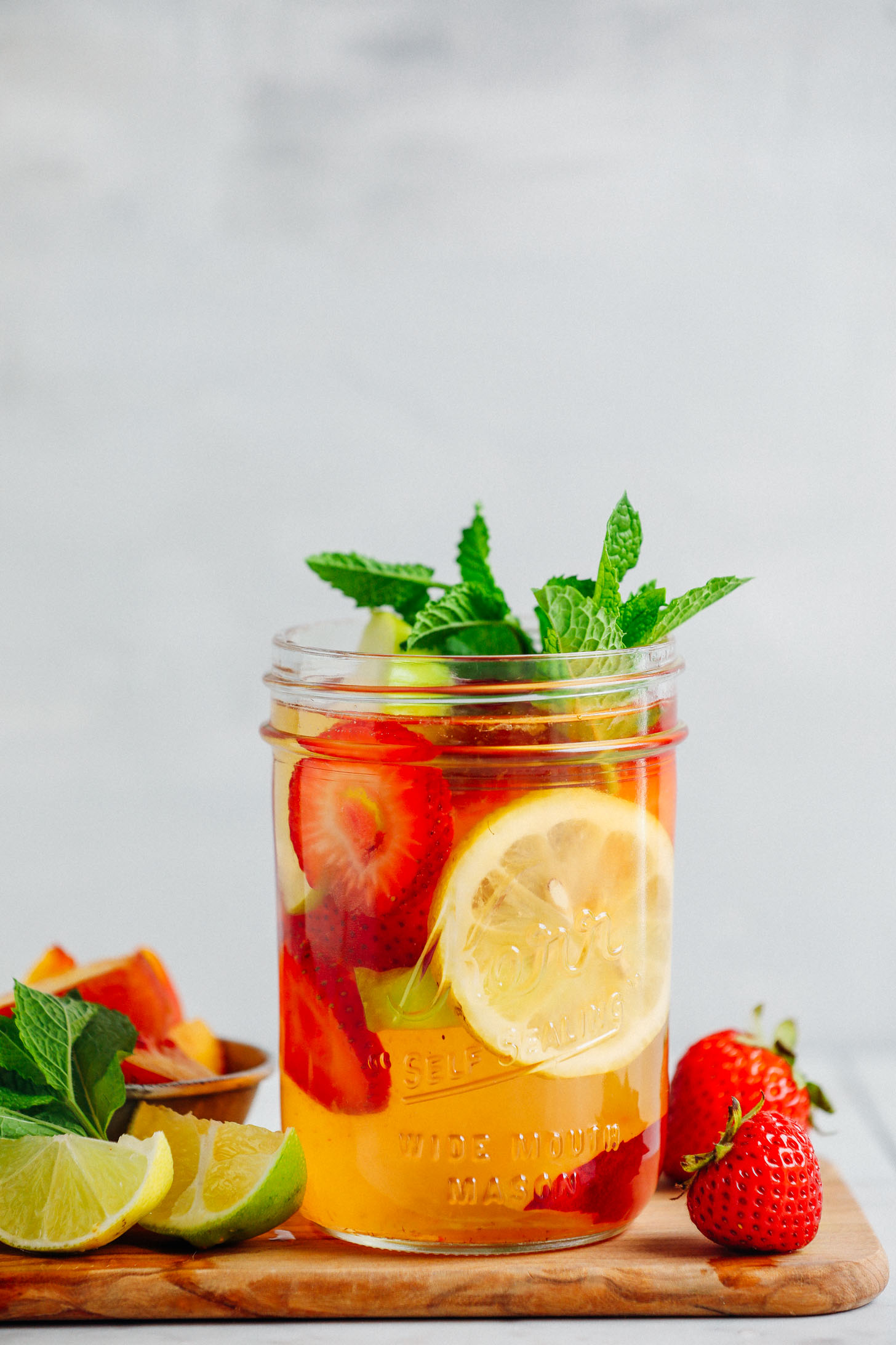 Close up shot of a mason jar with Easy Traditional White Sangria with fresh mint