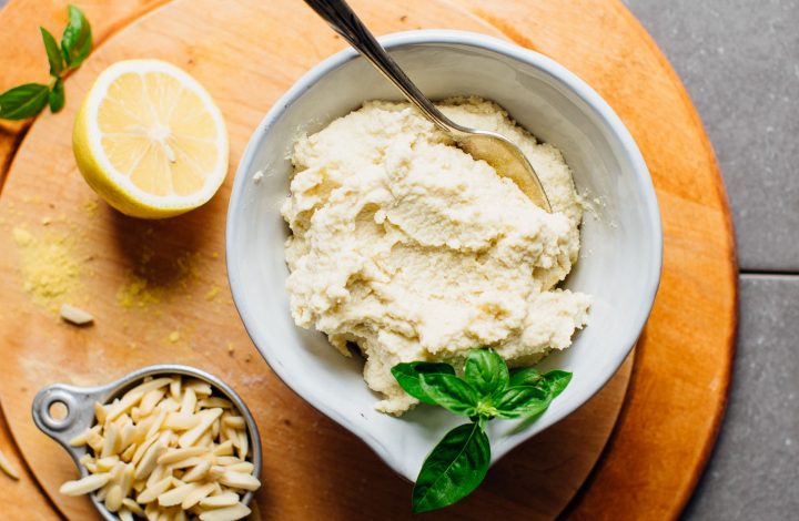 Wooden cutting board with a bowl of WHIPPED Vegan Ricotta Cheese