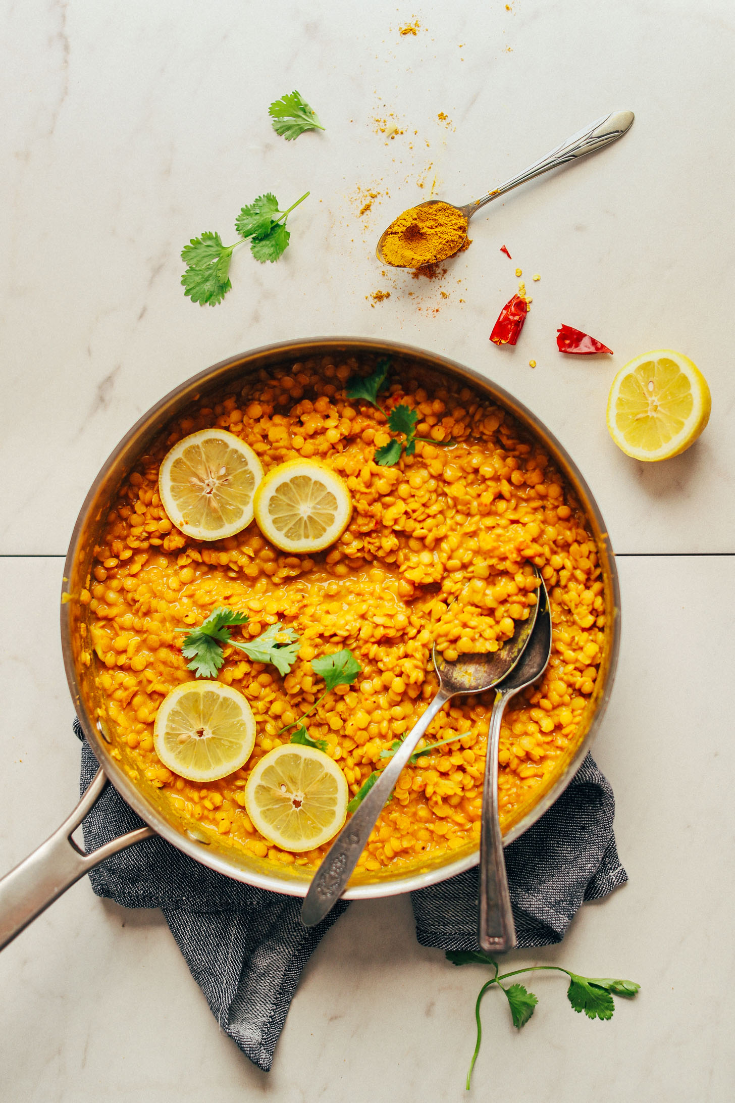 A large pan of Coconut Curried Golden Lentils topped with fresh lemon slices