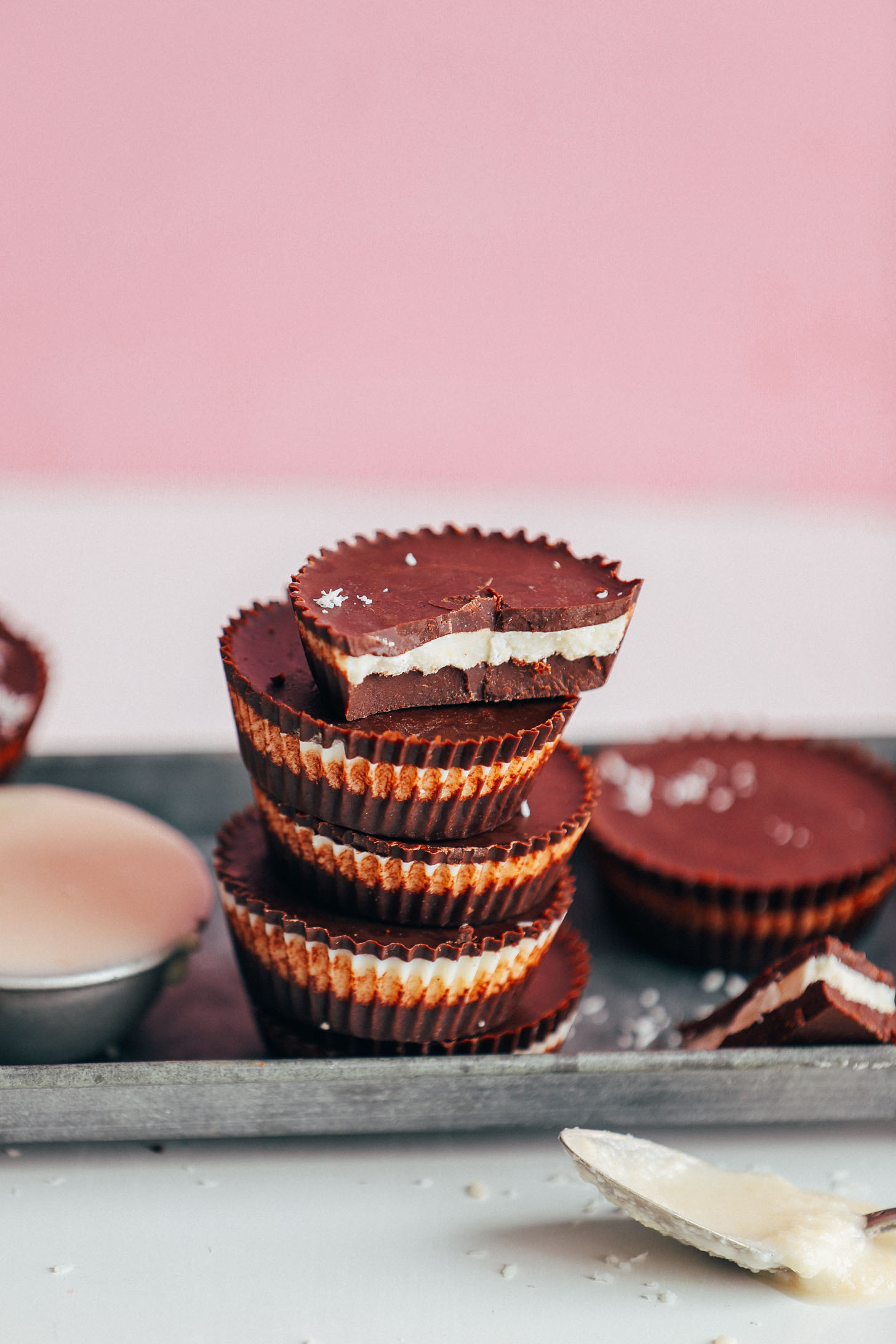 Close up shot of a stack of homemade Coconut Butter Cups that are plant-based and naturally sweetened
