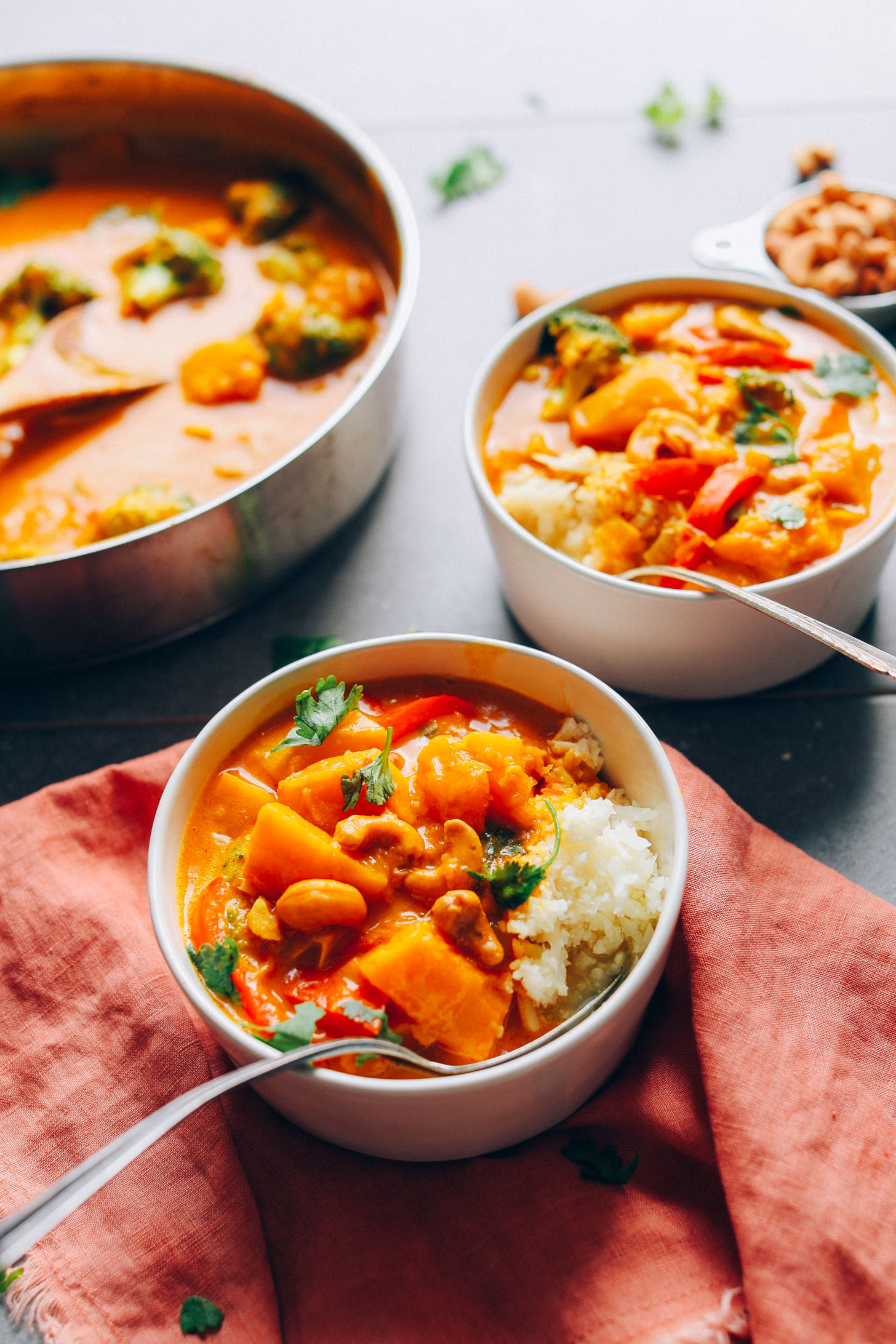 Up close shot of two bowls of vegan Yellow Pumpkin Curry served with rice