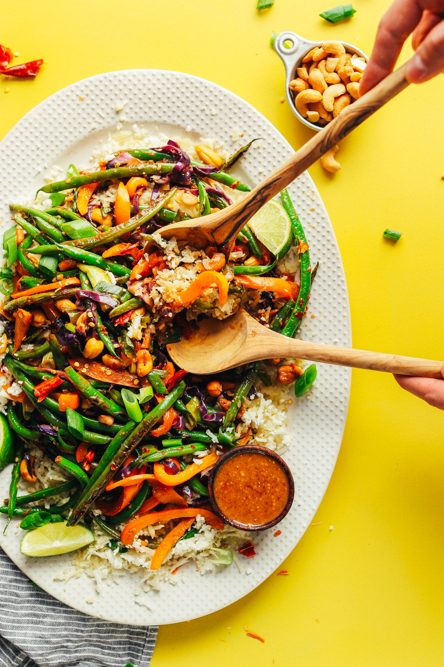 A large platter filled with a gluten-free plant-based meal of Cauliflower Rice Stir Fry