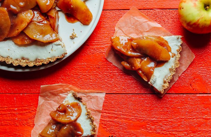 Slices of gluten-free, vegan Caramel Apple Tart on squares of parchment paper