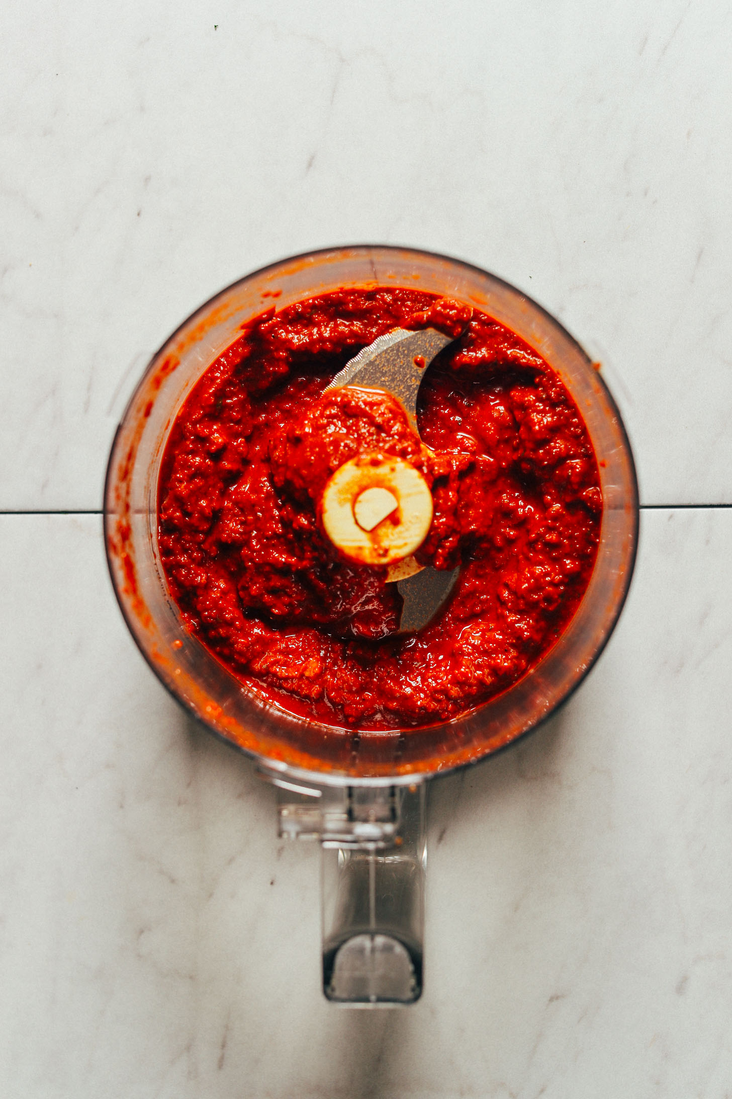 A food processor with freshly blended sauce for Moroccan-Spiced Lentils