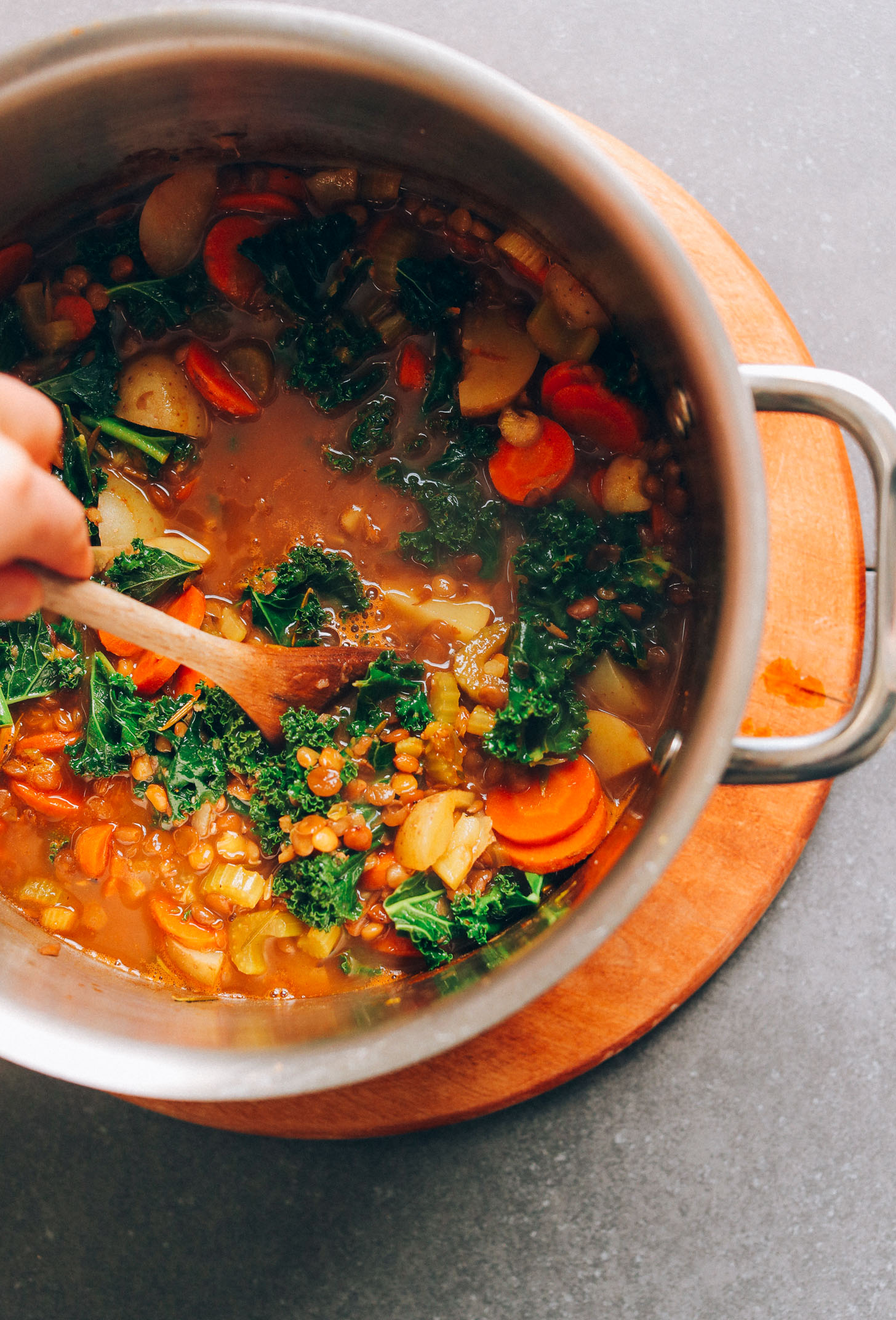Stirring a big pot of our easy lentil soup recipe