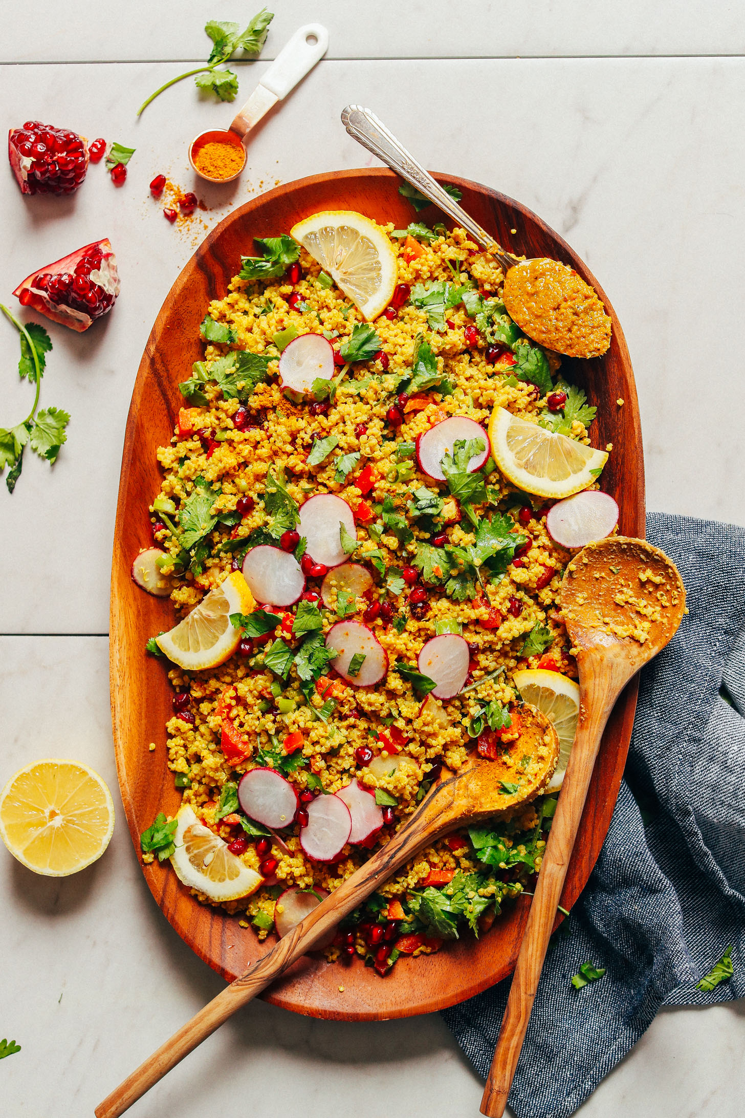 Large wood platter with gluten-free vegan Curried Quinoa Salad with fresh vegetables