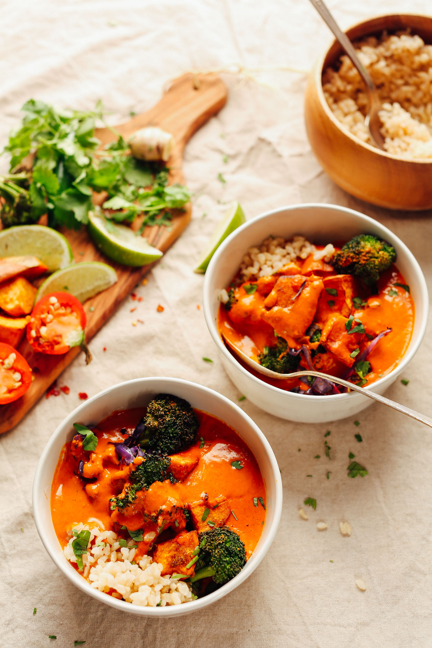 Bowls of Rich Red Curry with Roasted Vegetables served with brown rice for a delicious plant-based meal