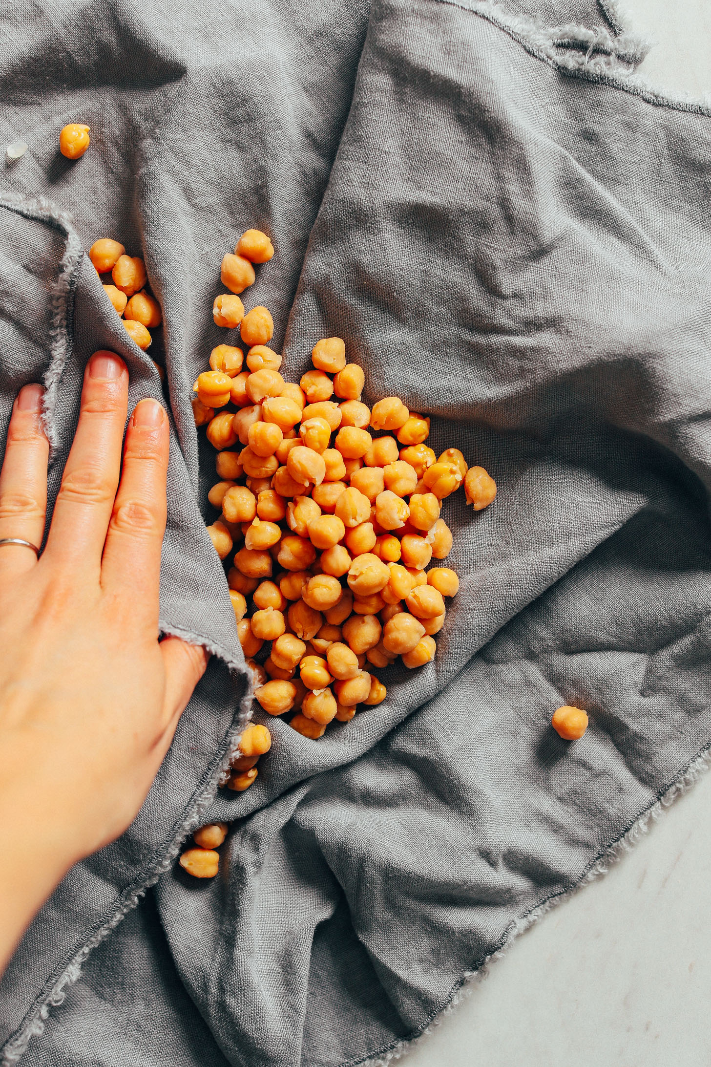 Using a dish towel to remove skins from chickpeas