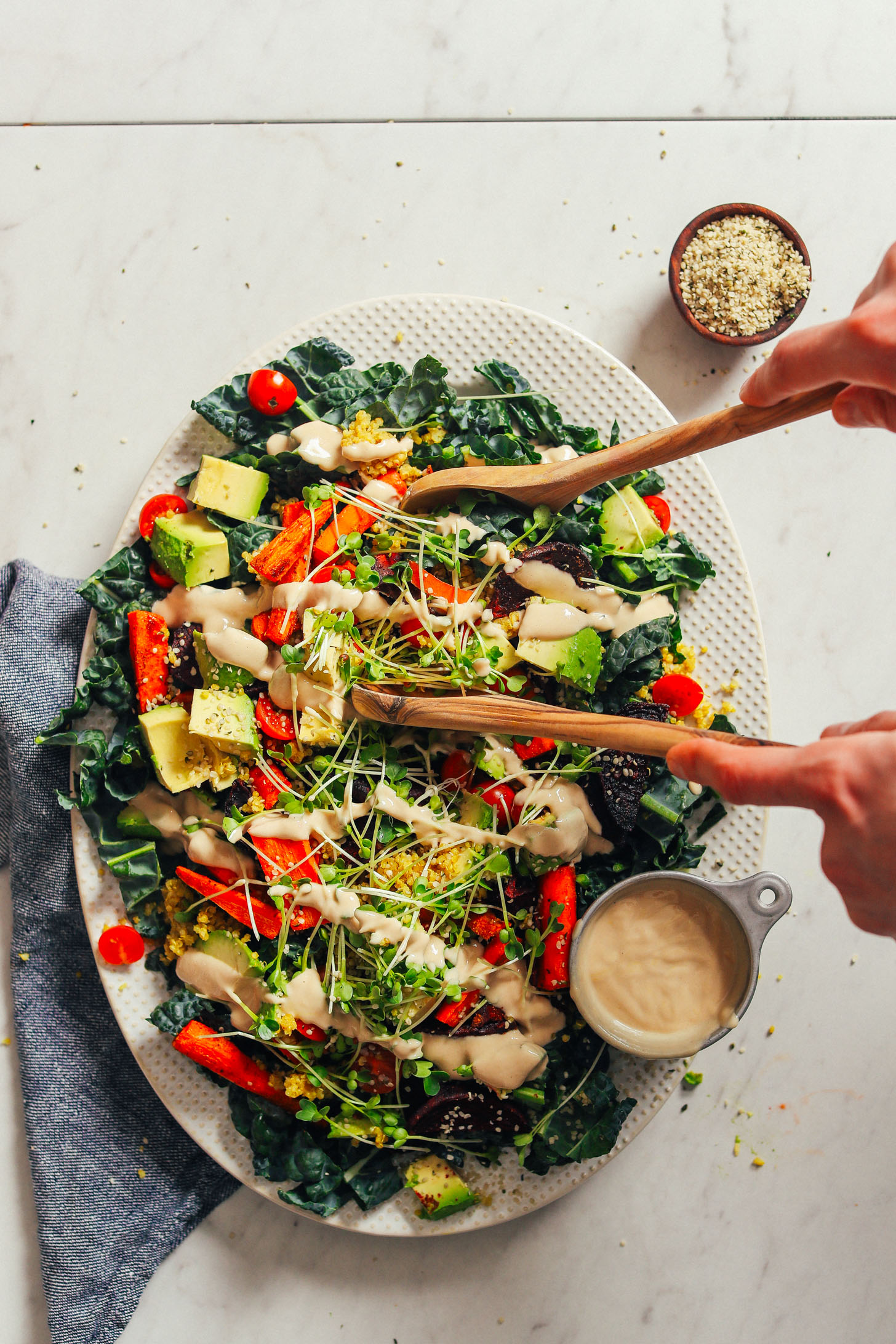 HEALTHY Loaded Kale Salad in just 30 minutes! Roasted and fresh veggies, sprouts, quinoa, and tahini dressing! #dinner #vegan #glutenfree #salad #healthy #minimalistbaker #recipe