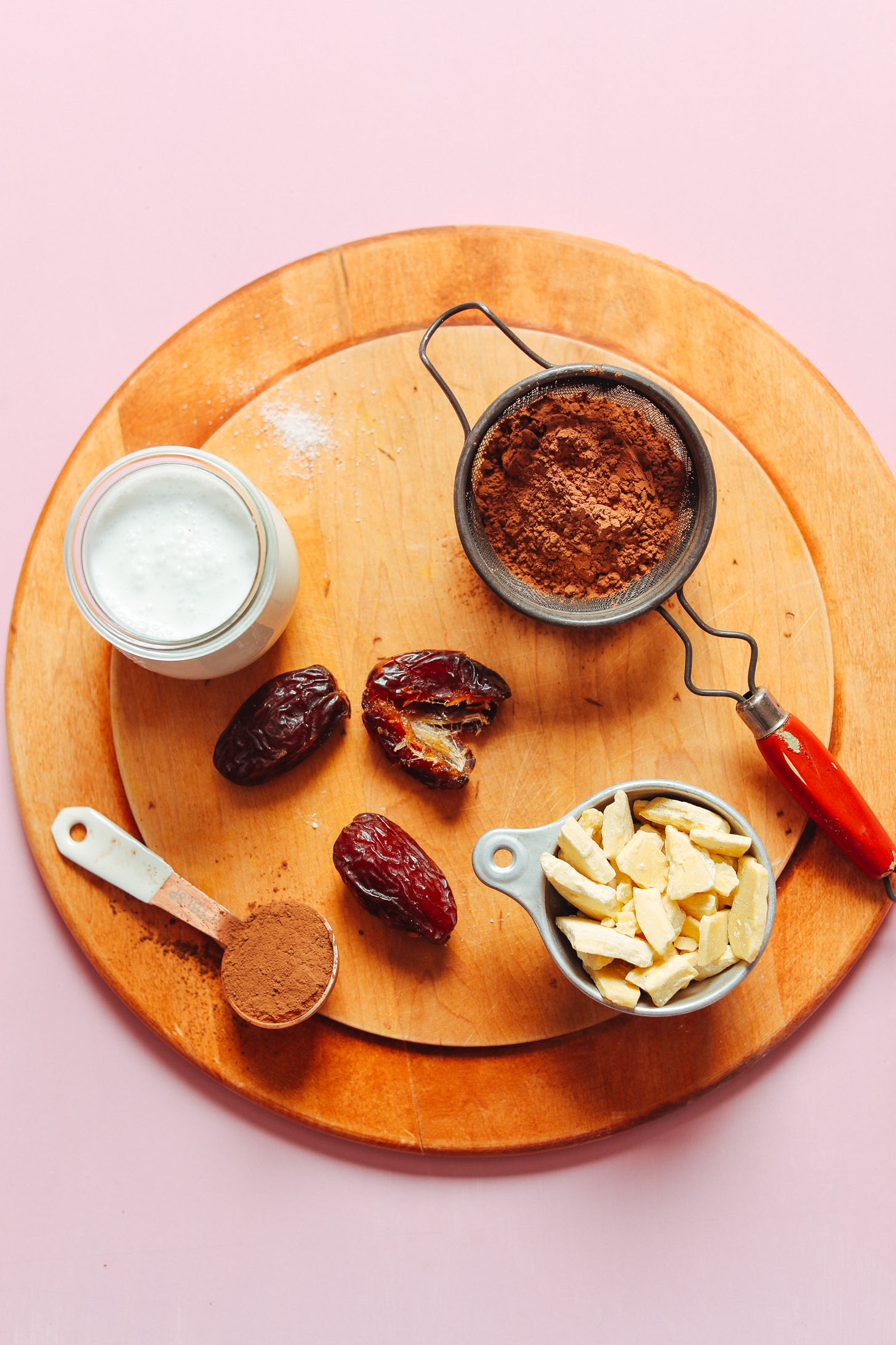 Cocoa powder, coconut milk, dates, and cocoa butter for making Naturally Sweetened Vegan Chocolate Mousse
