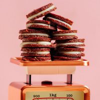 Vintage scale piled high with homemade Raw Vegan Oreos