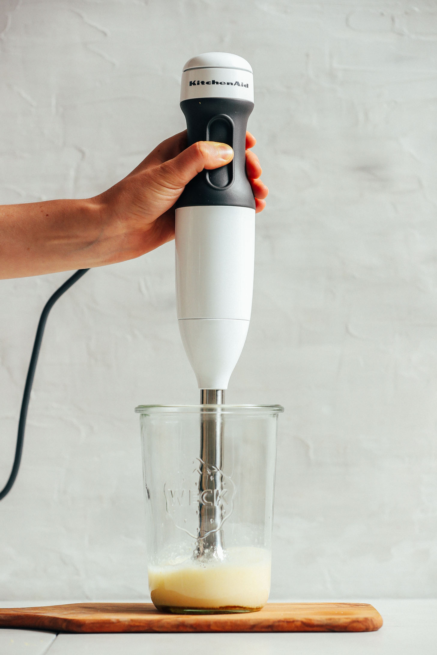 Using an immersion blender to make our homemade vegan mayo recipe