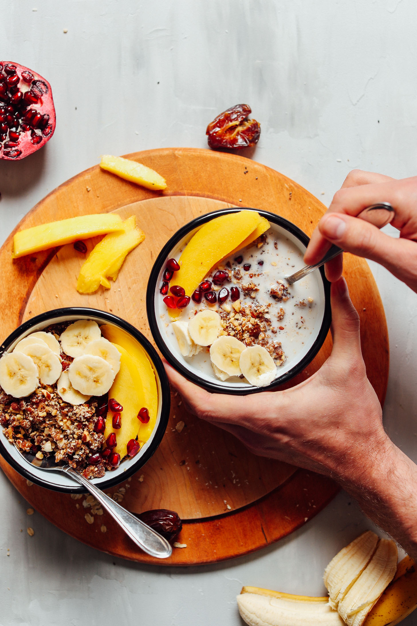 Wholesome bowls of gluten-free vegan granola served with coconut milk and fresh fruit