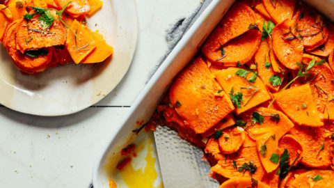 A small plate serving of Vegan Sweet Potato Butternut Squash Tortilla placed beside the freshly baked whole dish