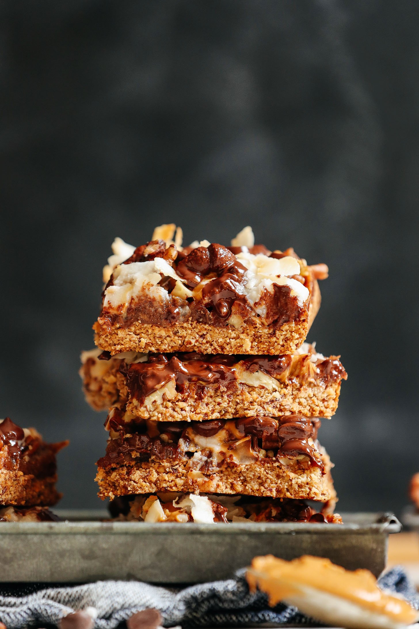 Stack of rich and gooey Vegan 7-Layer Bars 