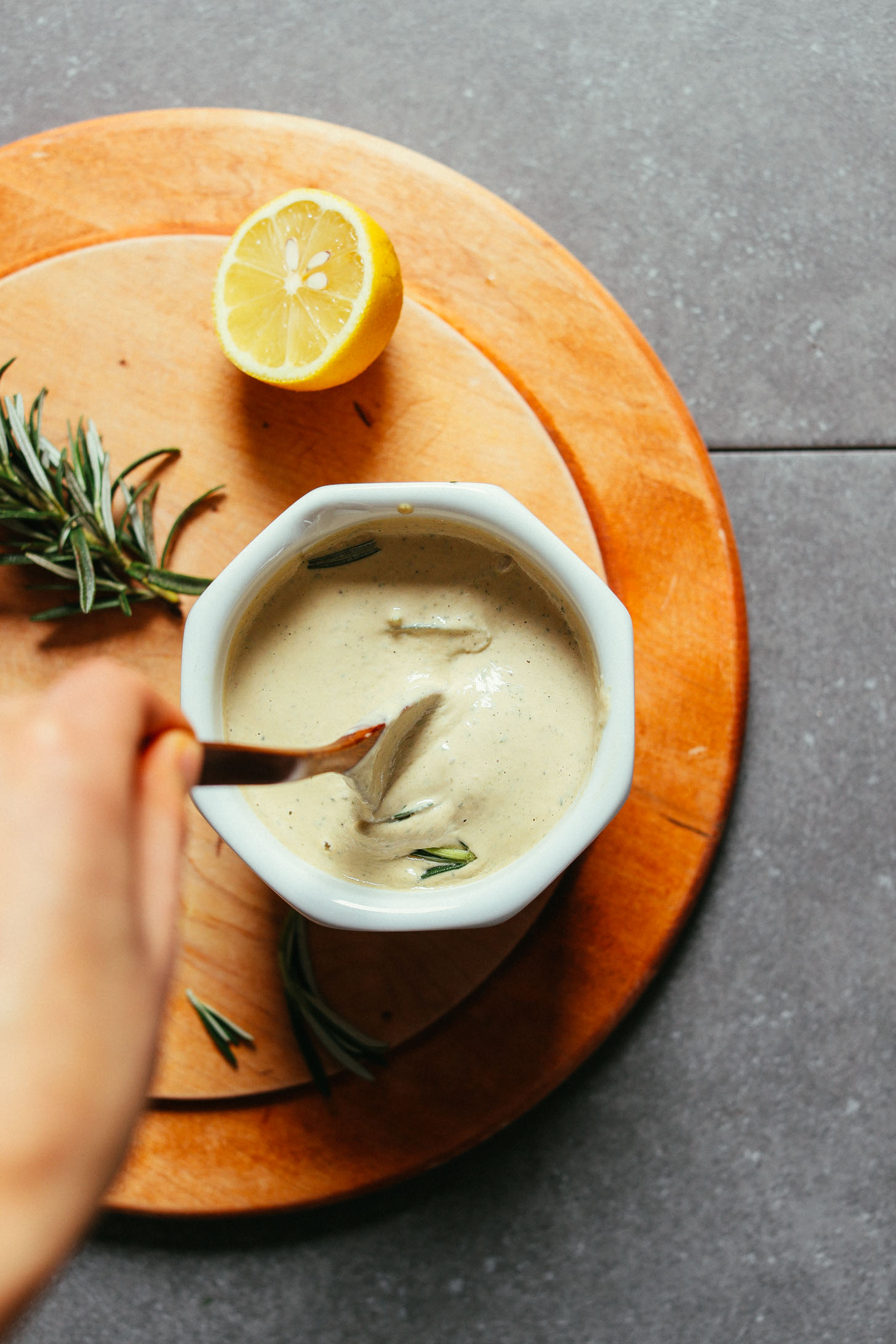 Bowl of insanely delicious and versatile Rosemary Tahini Dressing for topping salad