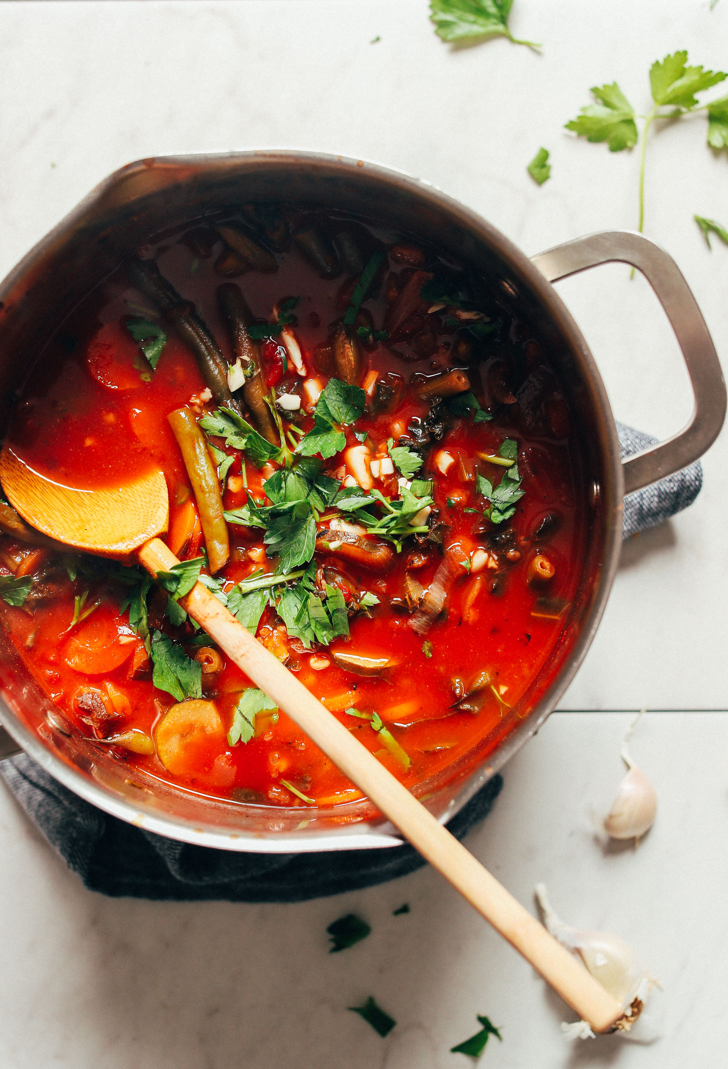 Stirring a big pot of our nourishing Fire-Roasted Tomato Veggie Mung Bean Soup