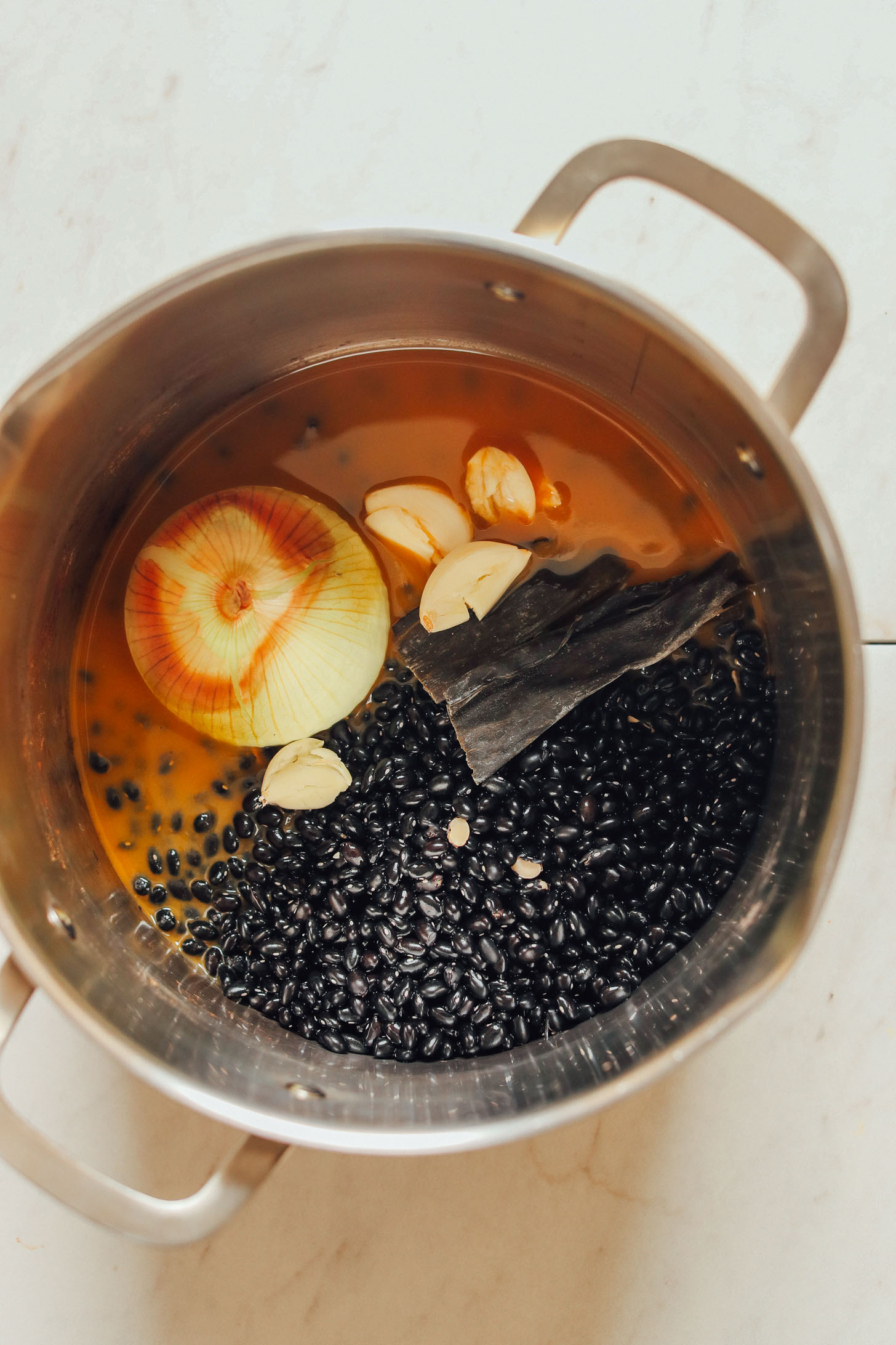 A large pot filled with ingredients for making Easy 1-Pot Black Beans