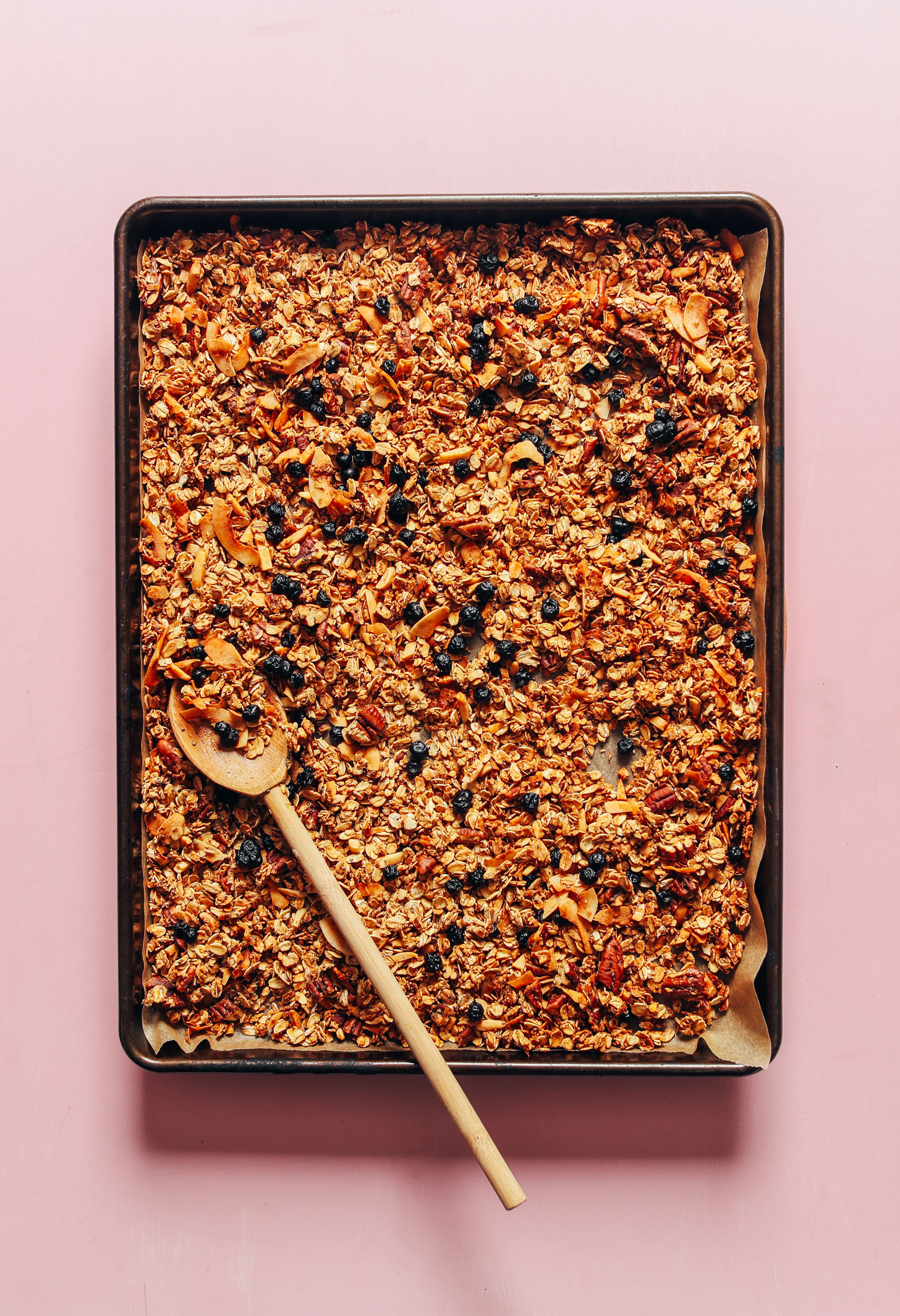 Parchment-lined baking sheet filled with homemade gluten-free vegan granola