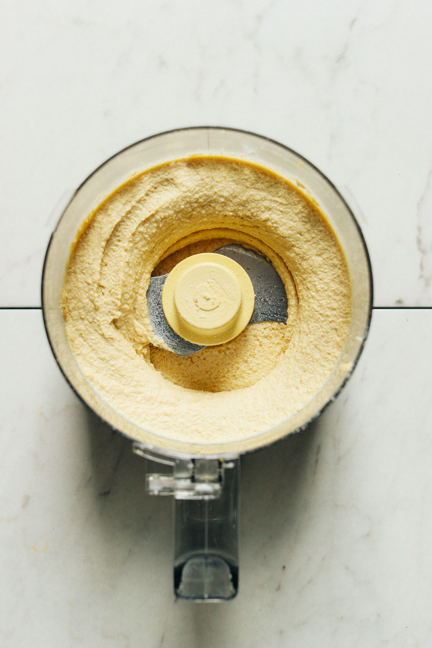 Food processor with freshly blended rich vegan cheese