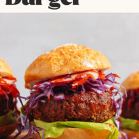 Hearty vegan black bean burgers on a wood cutting board