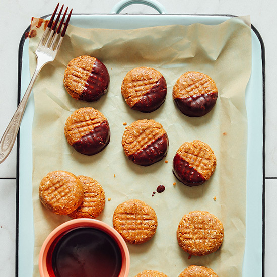 Tray of 3-Ingredient Vegan Peanut Butter Cookies with some half dipped in chocolate